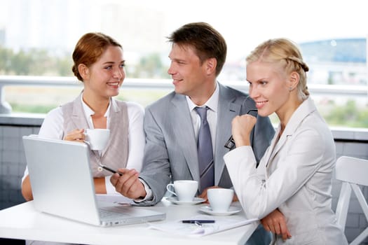 Image of businesspeople discussing new project or plan at meeting