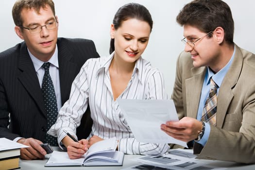 Confident boss is showing research results to his team in the office