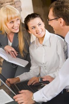 Portrait of two women looking at their boss in the office