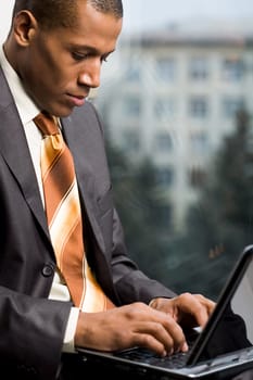Photo of handsome employee working in office with laptop in front