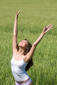 Portrait of beautiful woman in underwear raising hands outdoor