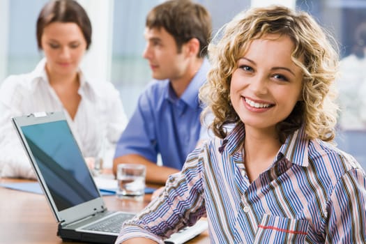 Portrait of successful young business woman smiling in the office