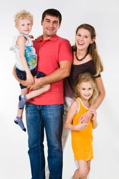 Portrait of father holding boy with mother embracing daughter near by