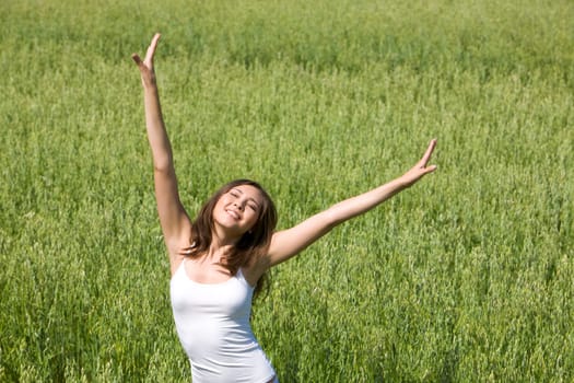 Portrait of attractive woman having joy in the field