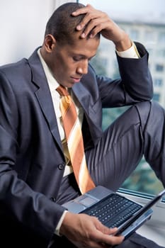 Photo of handsome employee working in office with laptop in front