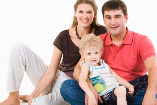 Photo of mother, father and son looking at camera on a white background