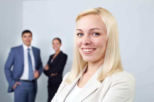 Portrait of a young woman looking at camera and smiling in office