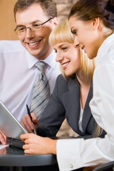 Portrait of three confident white collar office discussing a new plan