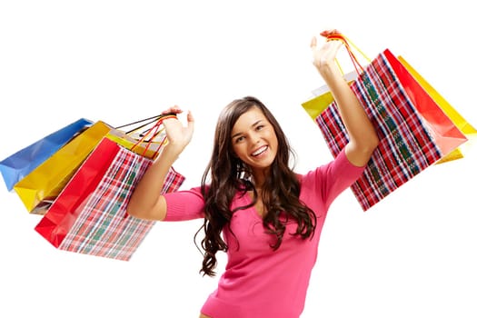 Portrait of happy girl with colorful paper bags looking at camera and smiling