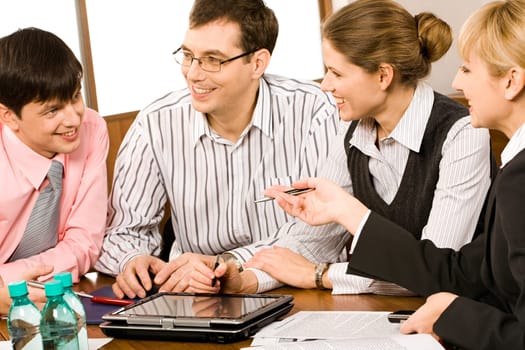 Portrait of business people sitting at the table and discussing a new project