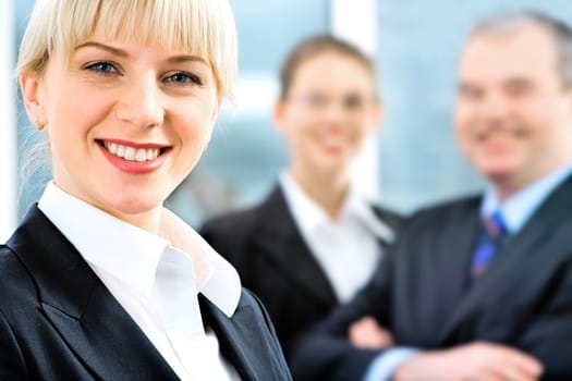 Portrait of self-confident employee in suit on the background of people