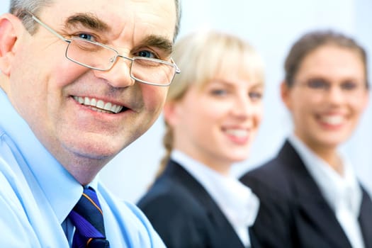 Image of faces of business people with boss in front