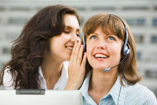 Confident  business woman is talking to her coworker