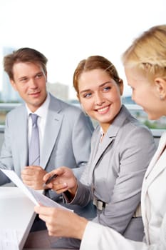 Image of successful businesspeople discussing plan at meeting in office
