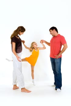 Image of young girl doing exercise holding her parents by hands