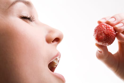 Image of pretty girl with open mouth and ripe strawberry in hand