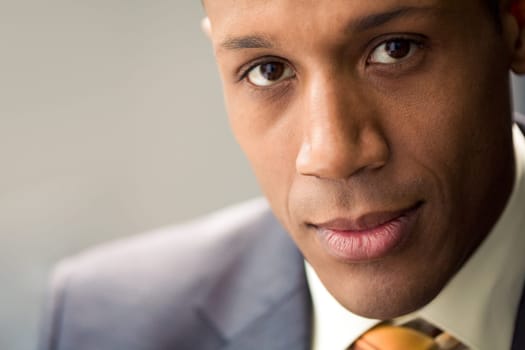 Confident businessman looking at camera with peaceful expression