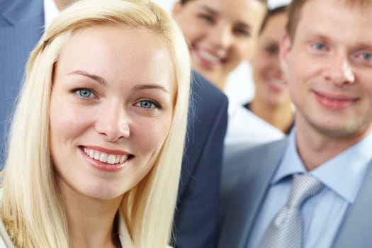 Young businesswoman smiling among her colleagues