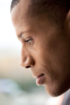 Profile of mans face with calm expression on it over blurry background