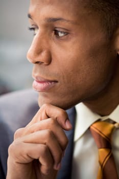 Thinking specialist touching his chin and looking aside