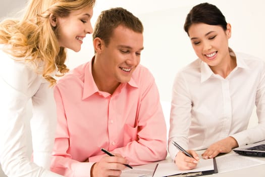 Photo of successful business team working with papers while young female standing near by