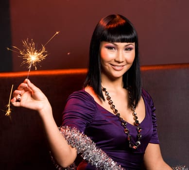 Portrait of smiling woman with Bengal light on Christmas night