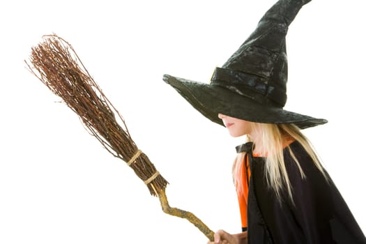Photo of girl in witch costume holding broom