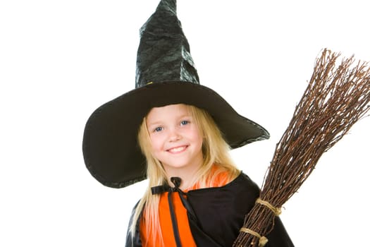 Photo of girl in halloween costume and broom smilling at camera