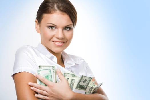 Portrait of young woman holding money on a white background