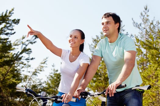 Portrait of a couple on bicycles looking into the distance