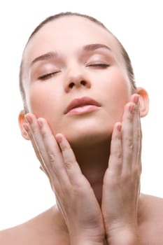 Close-up of pretty young woman touching her face