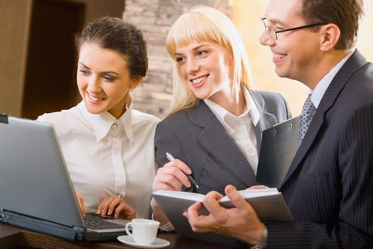 Portrait of three young confident specialists at a meeting