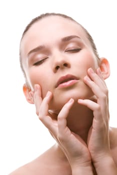 Close-up of pretty young woman with closed eyes touching her face