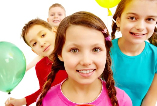Portrait of smiling kids holding colorful balloons with girl in front