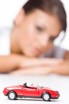 Image of toy pick-up with woman at background
