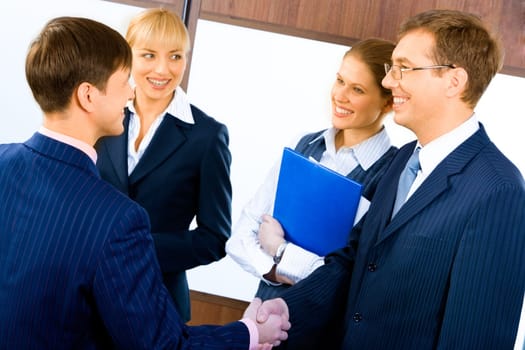 Business people shaking hands making an agreement at meeting