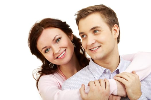 A young girl embracing her boyfriend, looking at camera and smiling