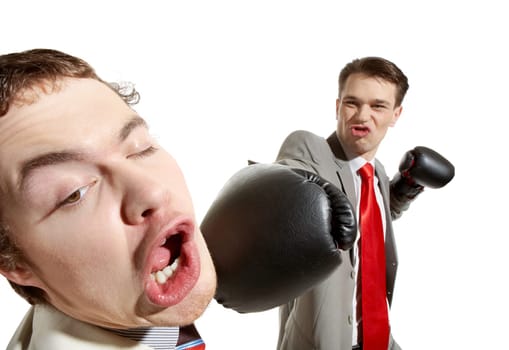 Portrait of aggressive businessman in boxing gloves kicking his rival