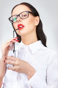 Gorgeous woman with glass of water looking at camera