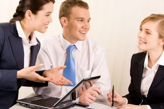 Image of confident woman explaining ideas about new project with man near by while looking at smiling employee