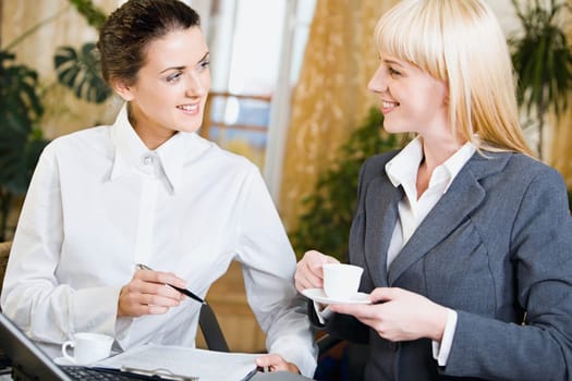 Portrait of  two contemporary businesspeople at a meeting in a cafe