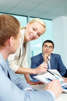 Pretty employer sharing ideas and explaining something in office
