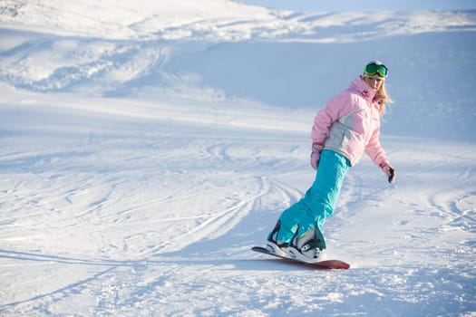 Photo of snowboarding female during vacation on winter resort