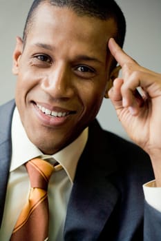 Portrait of cheerful businessman smiling and touching his head