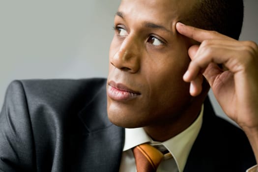 Pensive employee thinking of new ideas and looking aside
