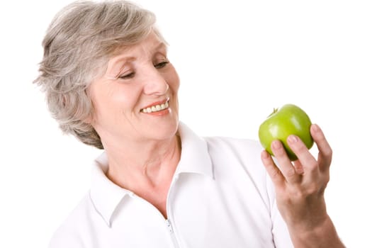 Portrait of aged female with green apple ready to eat it