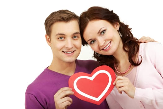 Portrait of a young happy couple holding paper heart