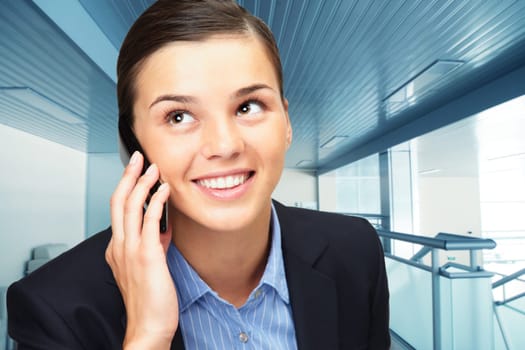 Photo of smart businesswoman calling somebody in office building