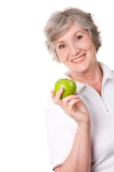 Portrait of aged female holding an apple and smiling