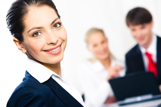 Close-up of happy woman looking at camera in working environment